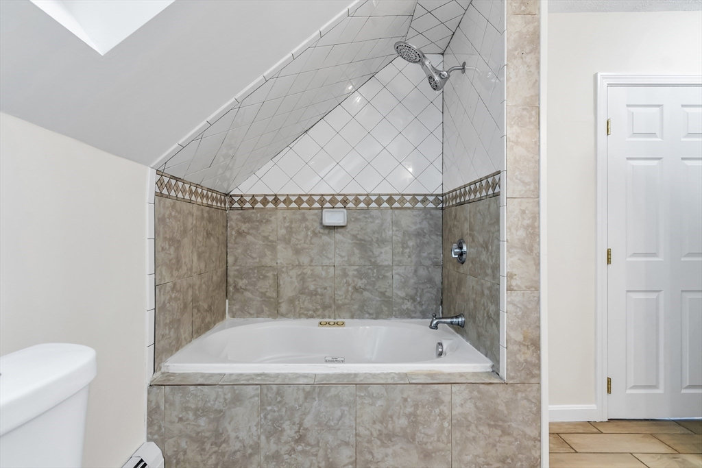 6 Dexter Street Haverhill, MA 01830 - Photo 40 of 42 a bathroom with a tub a toilet and a shower