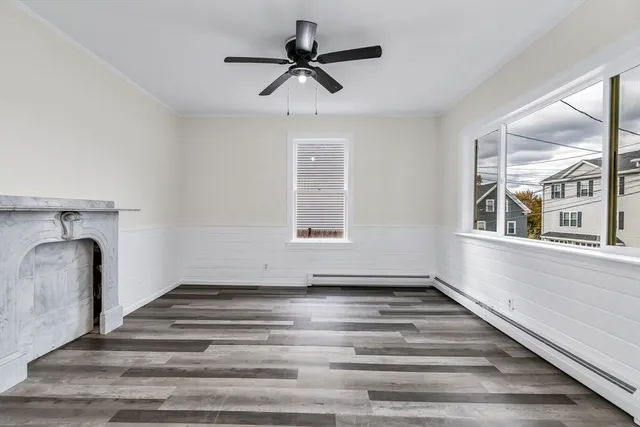 a view of living room with stainless steel appliances kitchen island granite countertop a stove and a sink