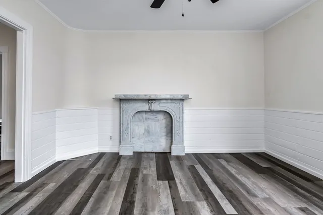 a kitchen with stainless steel appliances granite countertop white cabinets a stove a sink and a microwave