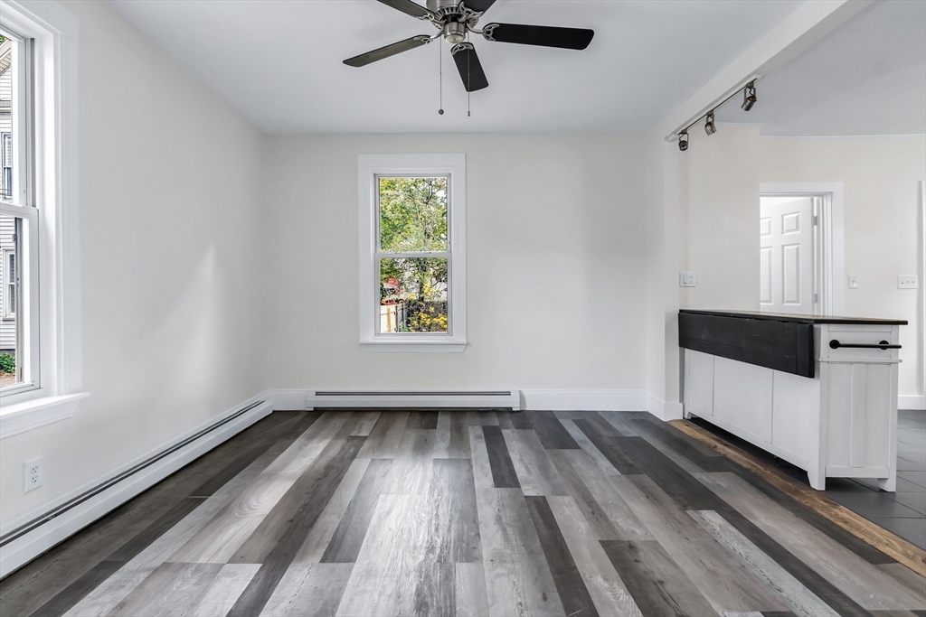 6 Dexter Street Haverhill, MA 01830 - Photo 10 of 42 a view of an empty room with a window and wooden floor