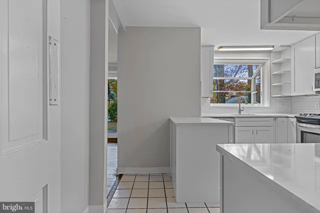 a kitchen with stainless steel appliances a sink and a window