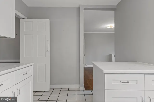 a utility room with cabinets washer and dryer