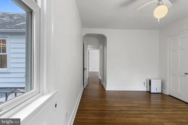 a view of a room with wooden floor and window
