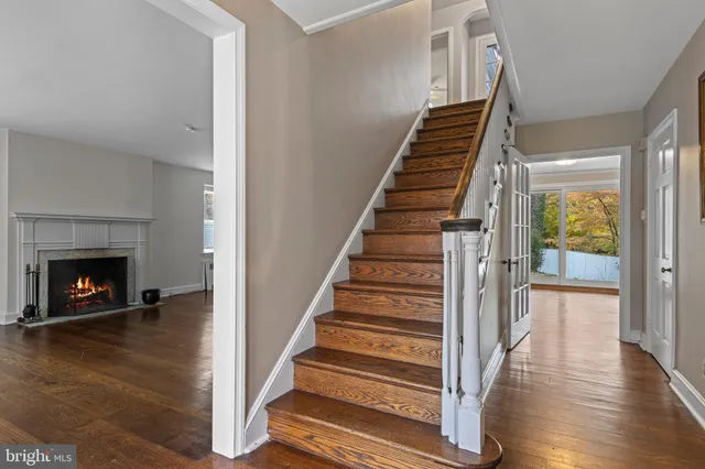 a view of an entryway with wooden floor fireplace and a window