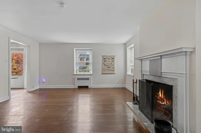 an empty room with windows and a fireplace