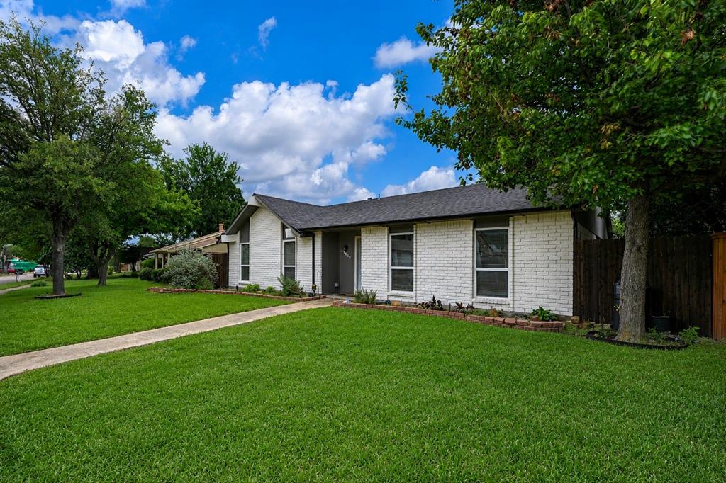 7318 Emory Oak Lane Dallas, TX 75249 - Photo 1 of 28 White brick exterior with dark trim and a dark shingle roof