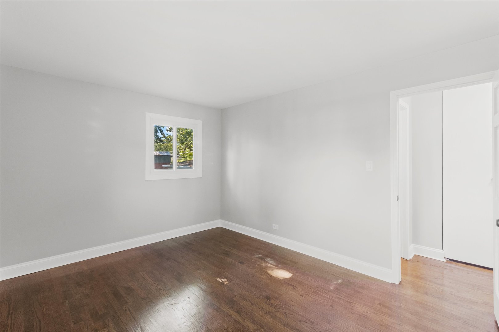 325 Indiana Street Park Forest, IL 60466 - Photo 18 of 28 an empty room with wooden floor and windows