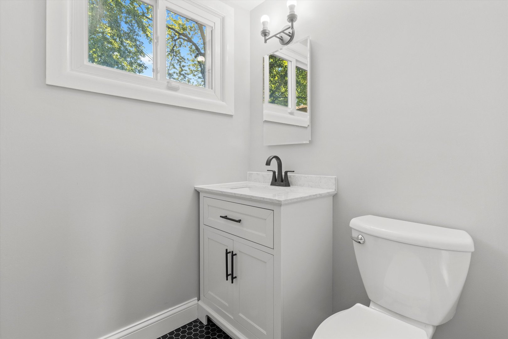 325 Indiana Street Park Forest, IL 60466 - Photo 22 of 28 a bathroom with a toilet sink and mirror