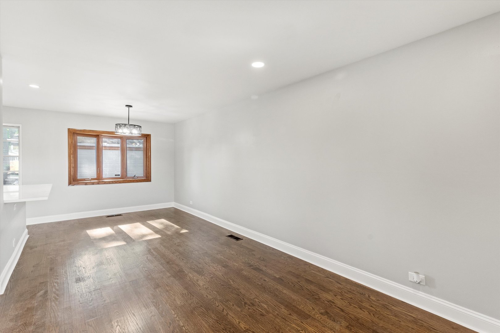 325 Indiana Street Park Forest, IL 60466 - Photo 10 of 28 an empty room with wooden floor cabinet and windows