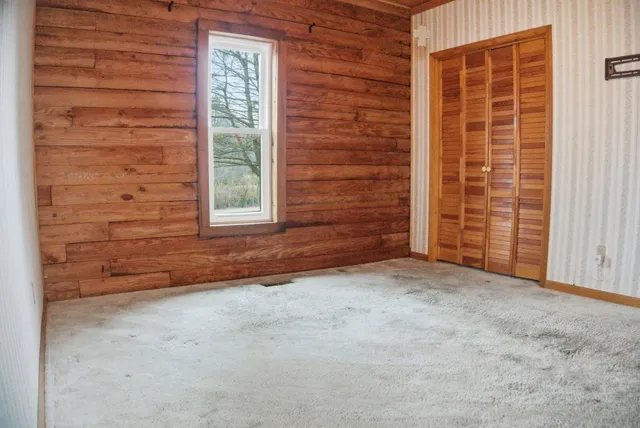 a view of an empty room with a door