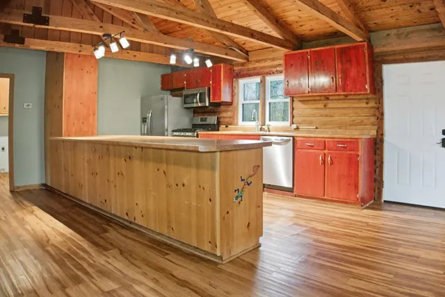 a kitchen with stainless steel appliances granite countertop a stove a sink and a refrigerator