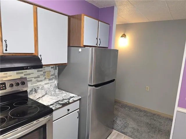 a kitchen with a stove and a refrigerator