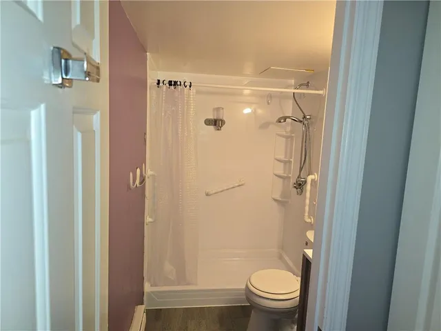 a bathroom with a granite countertop shower toilet and sink