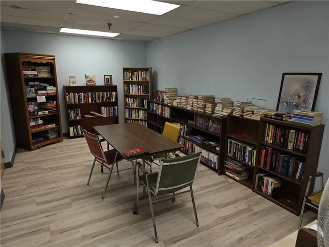 a kitchen with a dining table chairs and white appliances