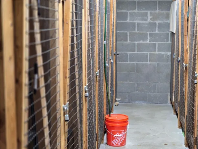 a view of a chair and tables in the back yard of the house