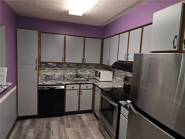 a kitchen with a sink stove and refrigerator