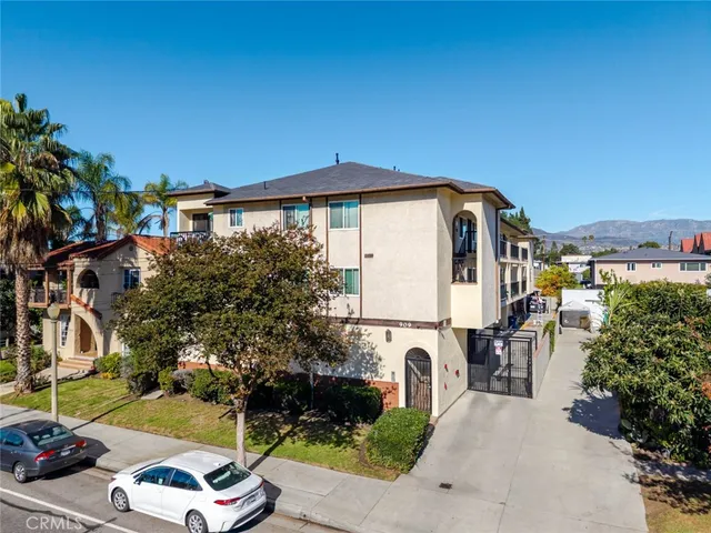 a view of a yard with table and chairs under an umbrella