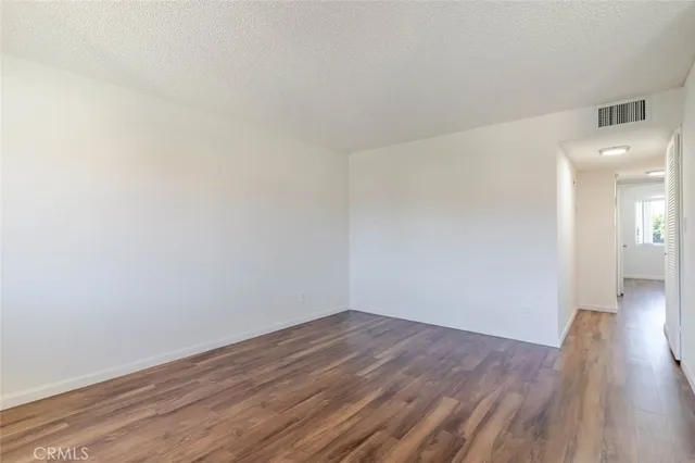 a view of a room with wooden floor