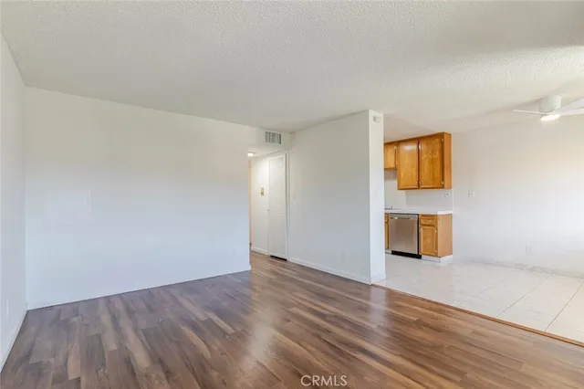 a view of an empty room and wooden floor