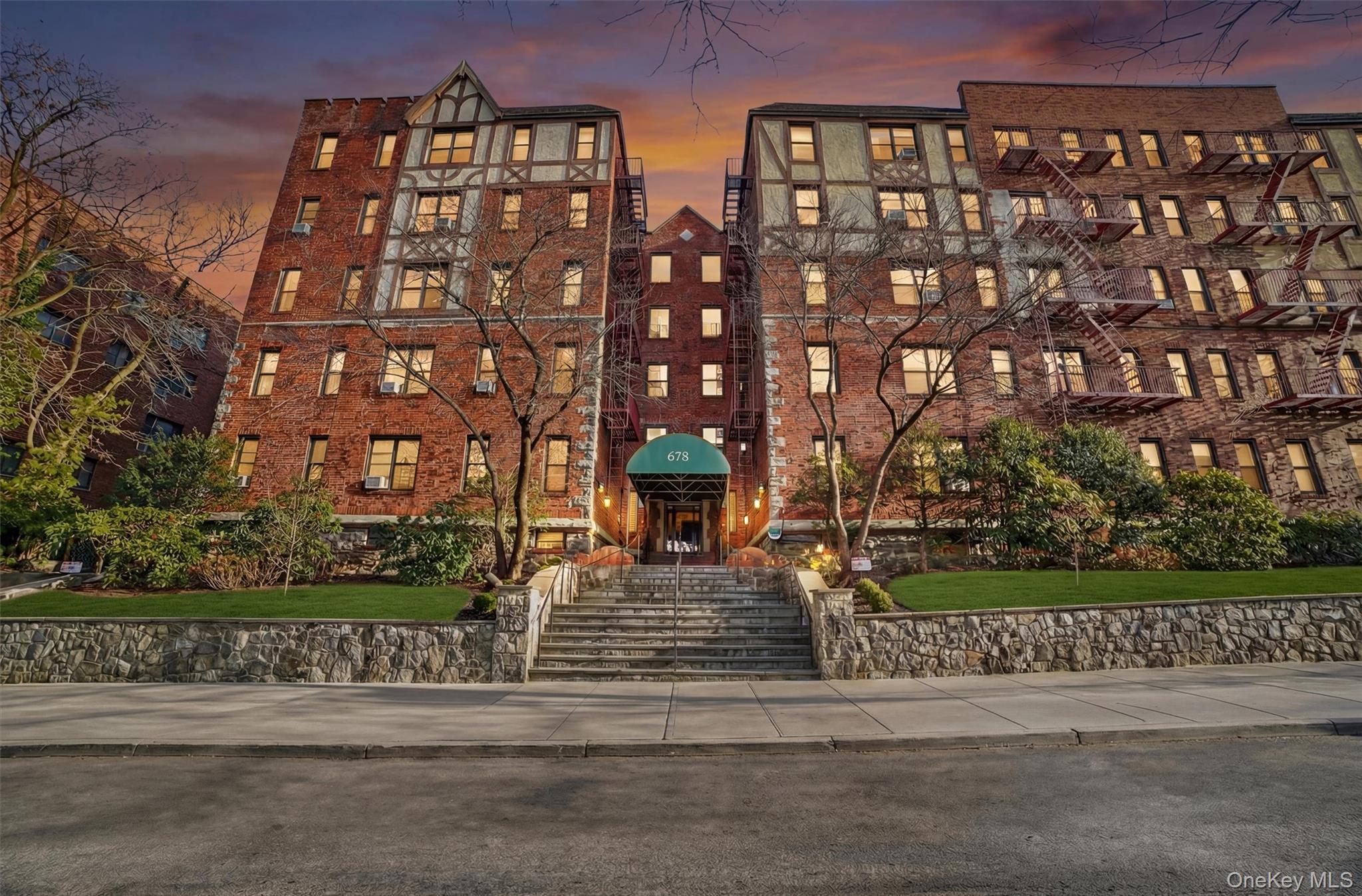 Property at dusk with a view of apartment building / complex