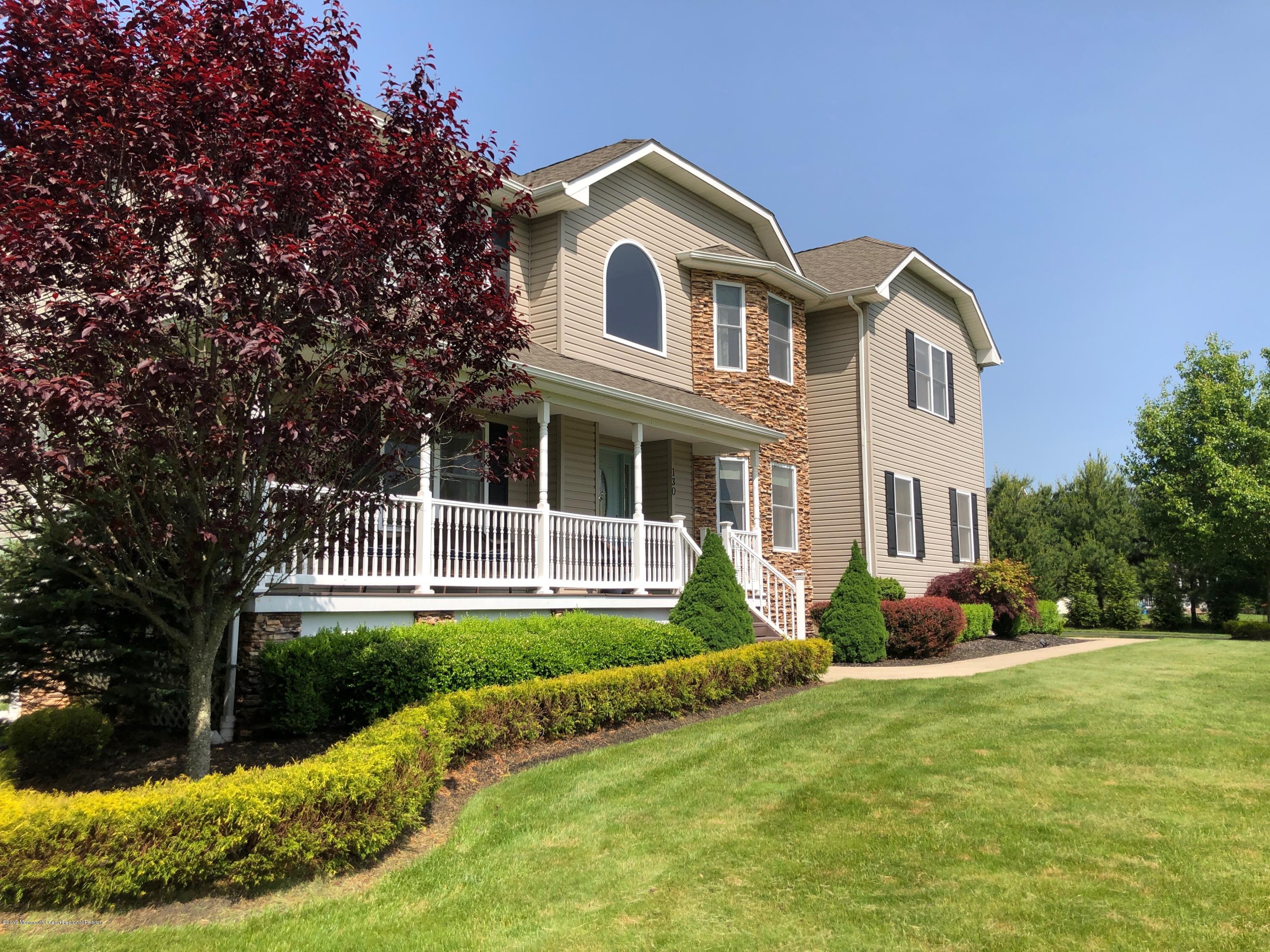 130 Crine Road Morganville, NJ 07751 - Photo 1 of 46 a front view of a house with garden