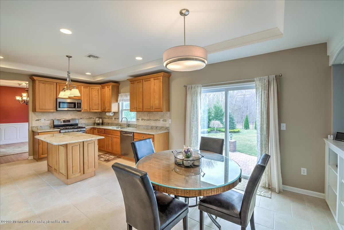 130 Crine Road Morganville, NJ 07751 - Photo 13 of 46 a view of a dining room with furniture window and outside view