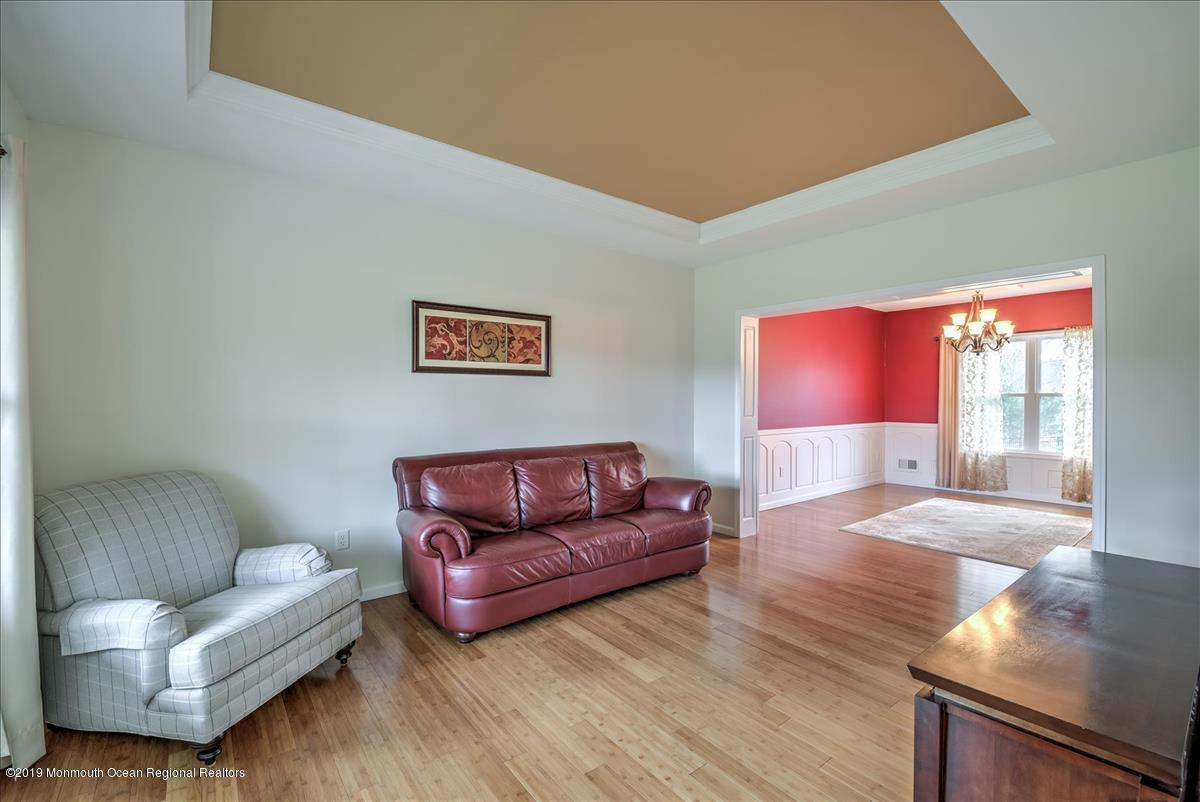 130 Crine Road Morganville, NJ 07751 - Photo 16 of 46 a living room with furniture and a wooden floor