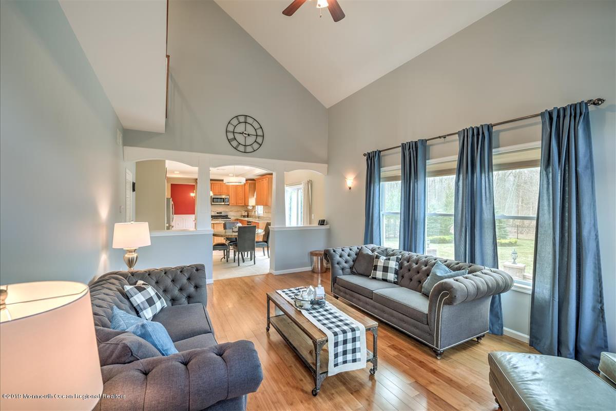 130 Crine Road Morganville, NJ 07751 - Photo 20 of 46 a living room with furniture and a large window