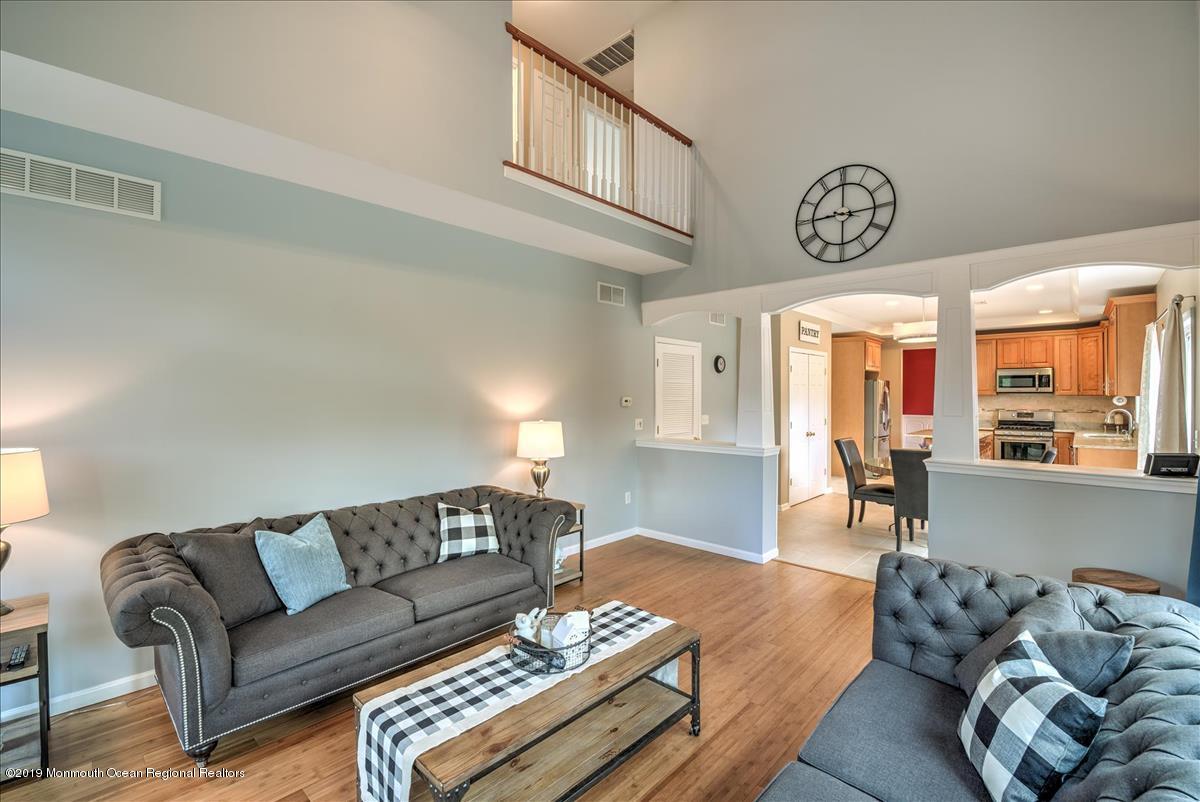 130 Crine Road Morganville, NJ 07751 - Photo 21 of 46 a living room with furniture and a window