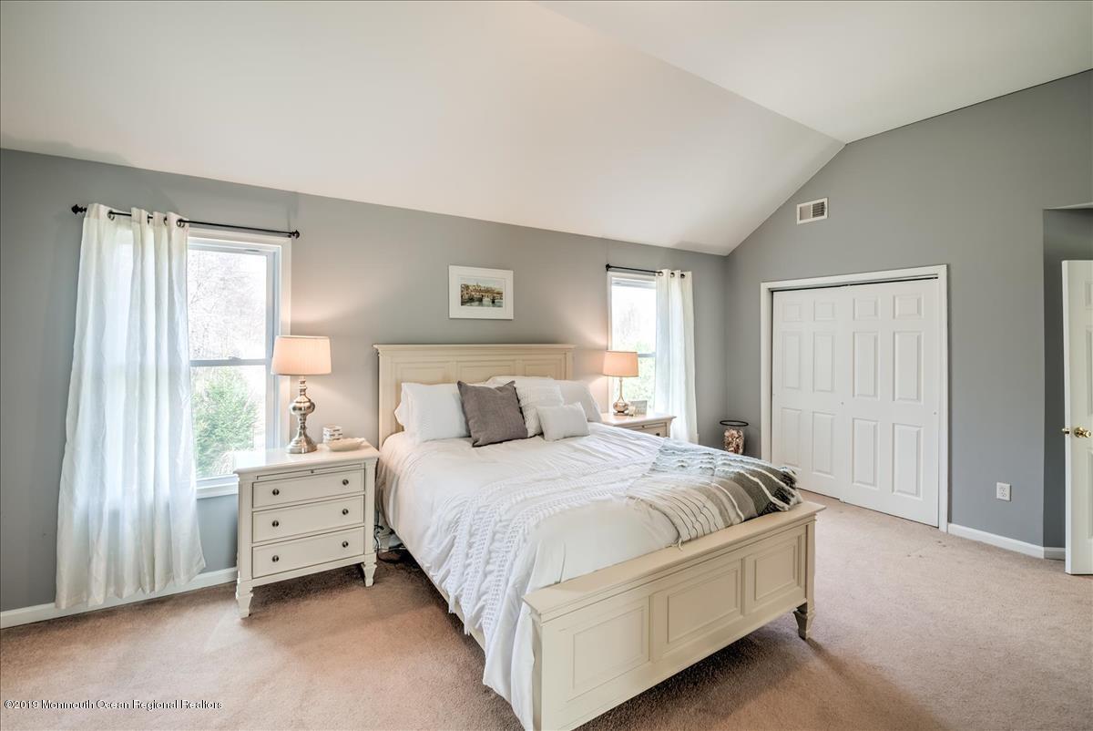 130 Crine Road Morganville, NJ 07751 - Photo 27 of 46 a bedroom with a bed and a window