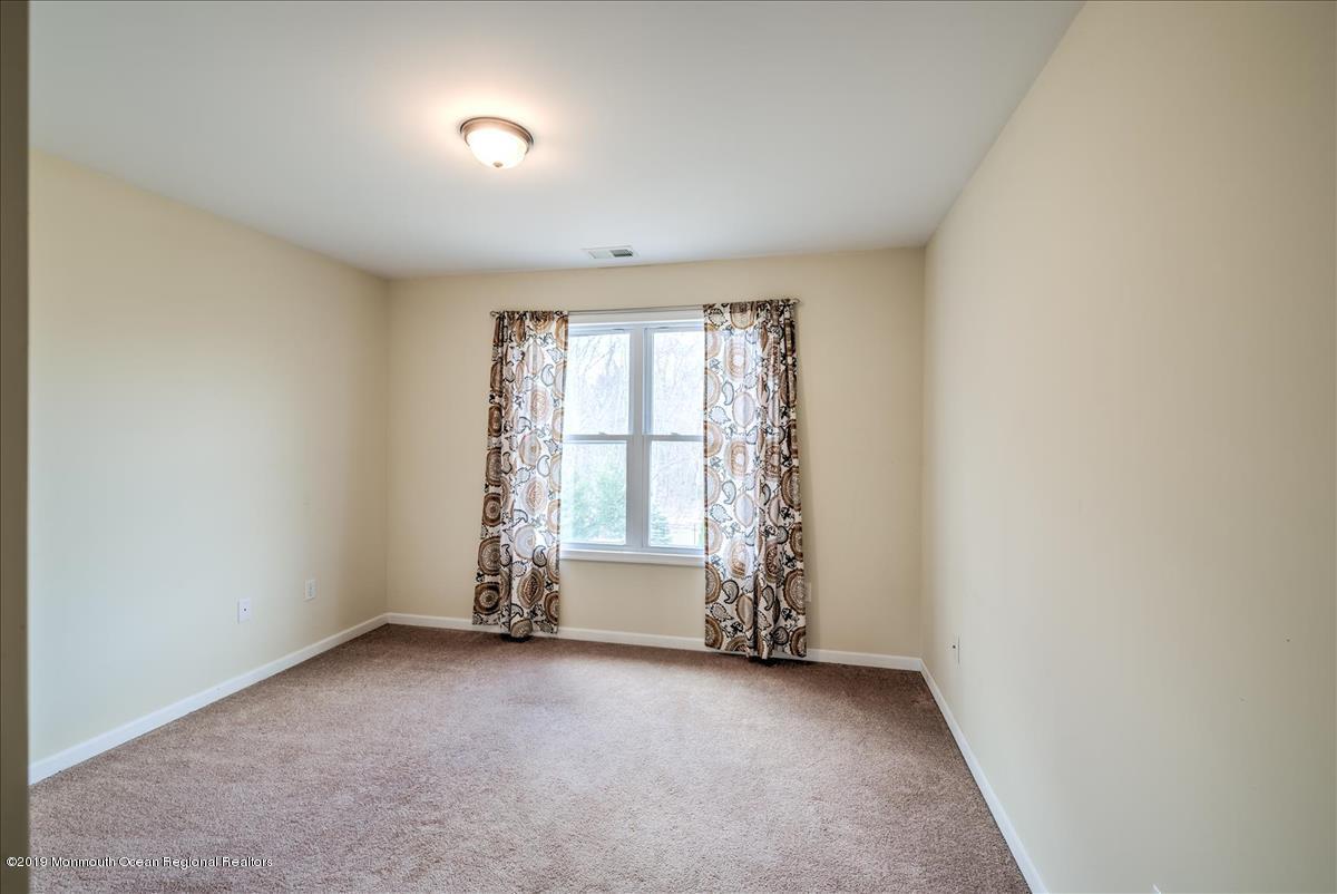 130 Crine Road Morganville, NJ 07751 - Photo 31 of 46 an empty room with windows