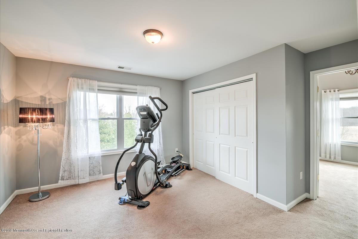 130 Crine Road Morganville, NJ 07751 - Photo 33 of 46 a view of a room with gym equipment