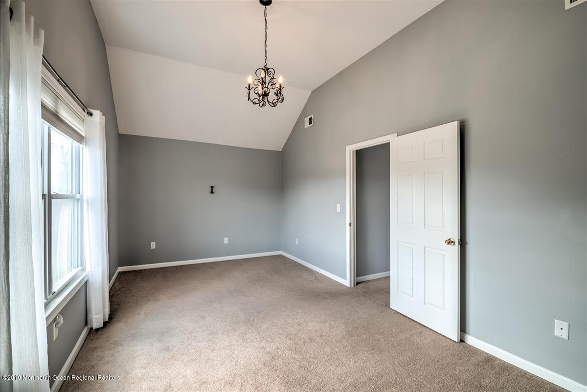 130 Crine Road Morganville, NJ 07751 - Photo 35 of 46 a view of an empty room with a window