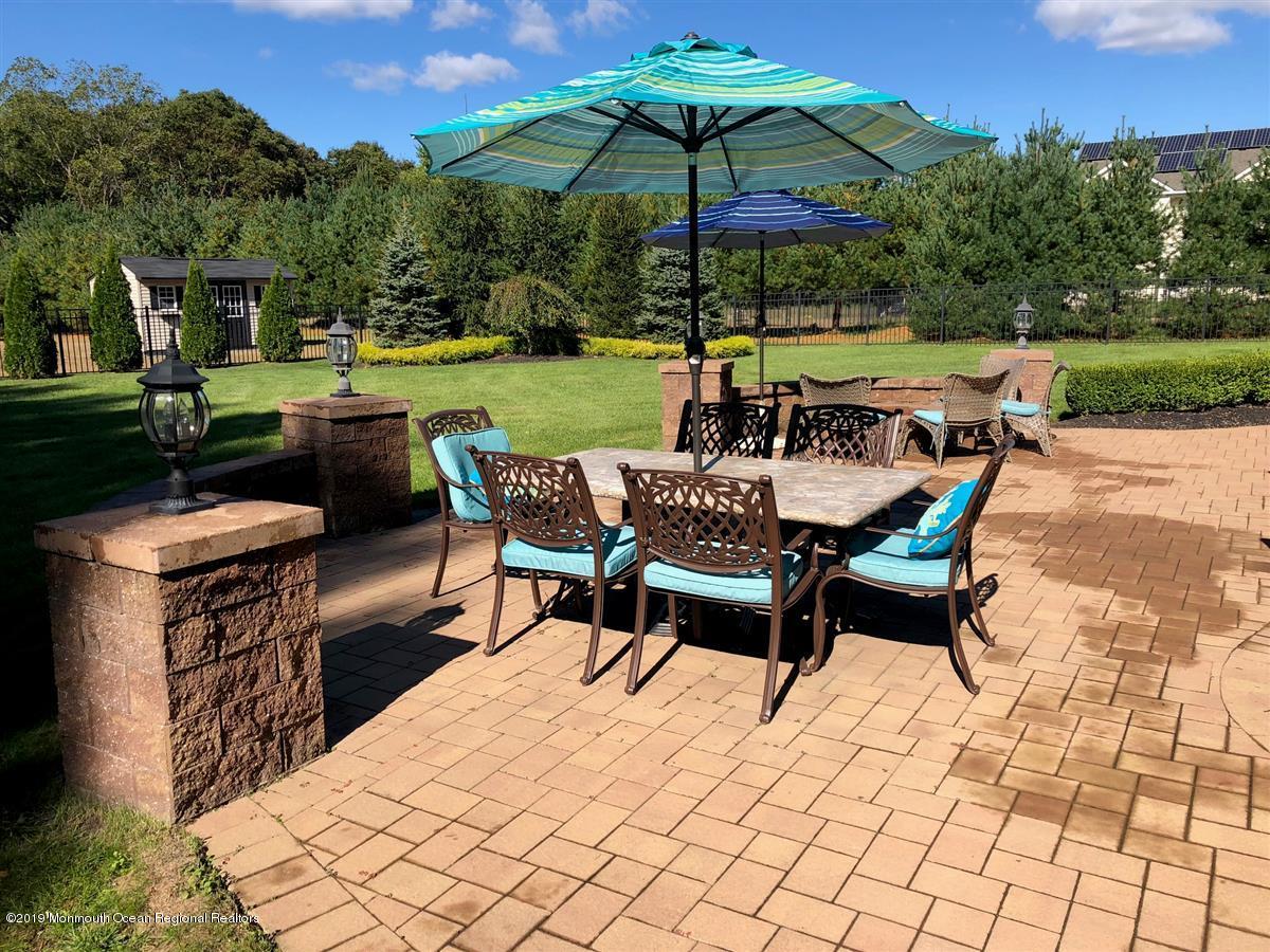 130 Crine Road Morganville, NJ 07751 - Photo 38 of 46 a view of a backyard with sitting area and furniture