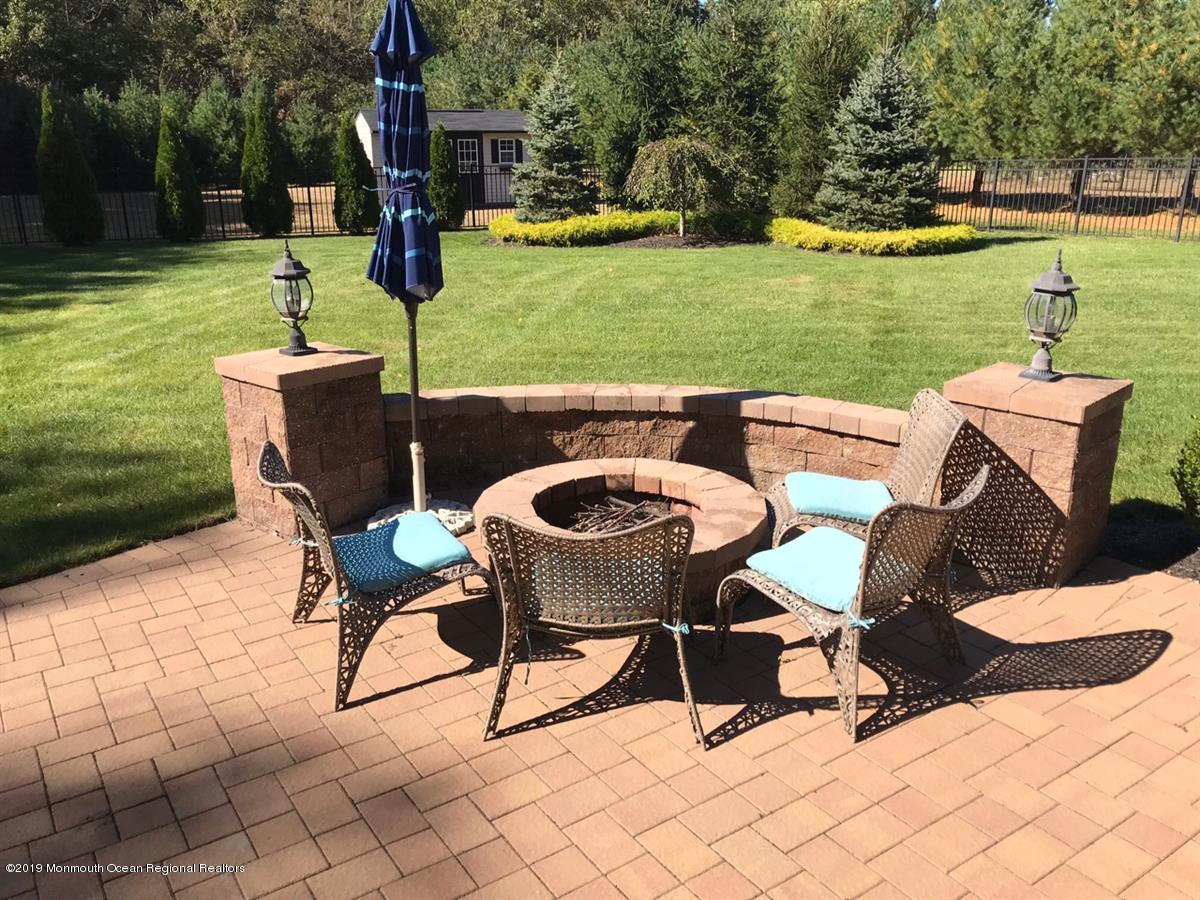 130 Crine Road Morganville, NJ 07751 - Photo 41 of 46 a swimming pool with some trees in the background