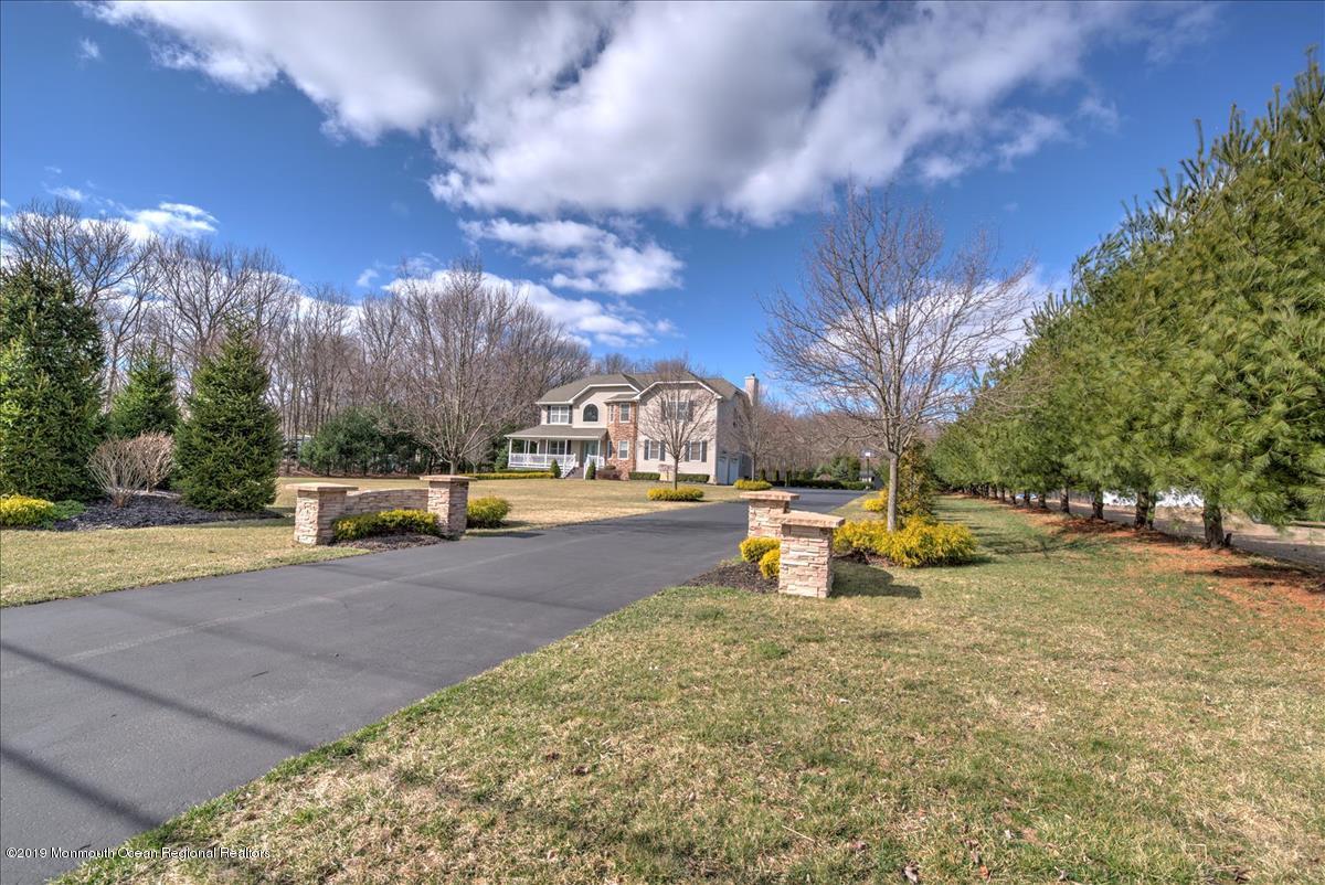 130 Crine Road Morganville, NJ 07751 - Photo 8 of 46 a view of a swimming pool with an outdoor space and seating area