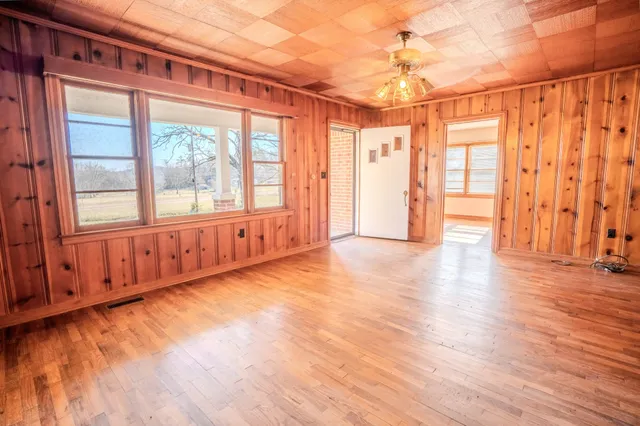 a view of a room with wooden floor and windows