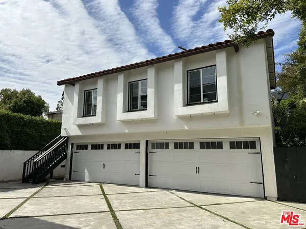 a front view of a house with garage