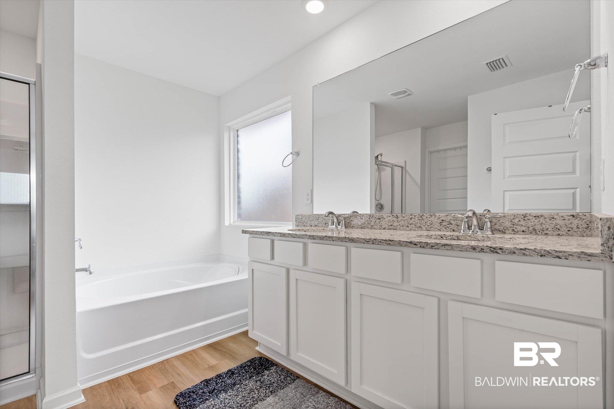 1105 Hayward Loop Foley, AL 36535 - Photo 12 of 30 Bathroom featuring a stall shower, a bath, light wood-style flooring, and double vanity