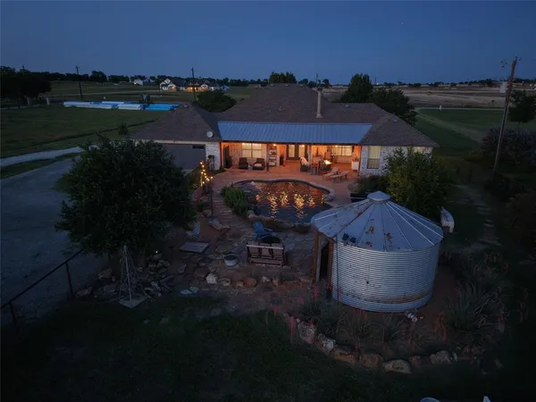 an aerial view of a house with garden space and lake view