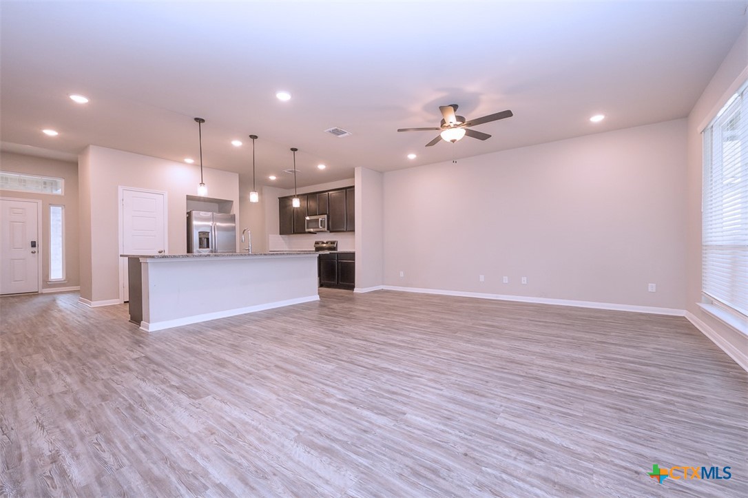 113 Lazy Lizzy Road Jarrell, TX 76537 - Photo 13 of 29 a view of a kitchen with a dishwasher and a stove top oven
