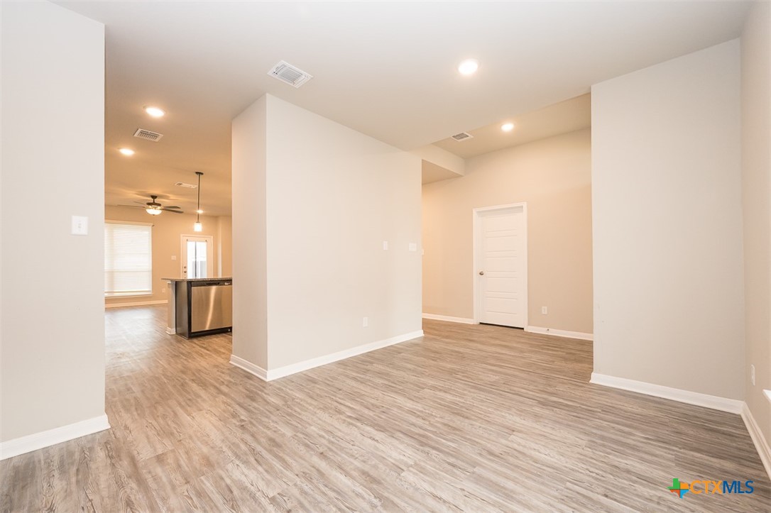 113 Lazy Lizzy Road Jarrell, TX 76537 - Photo 14 of 29 a view of a room with wooden floor and windows