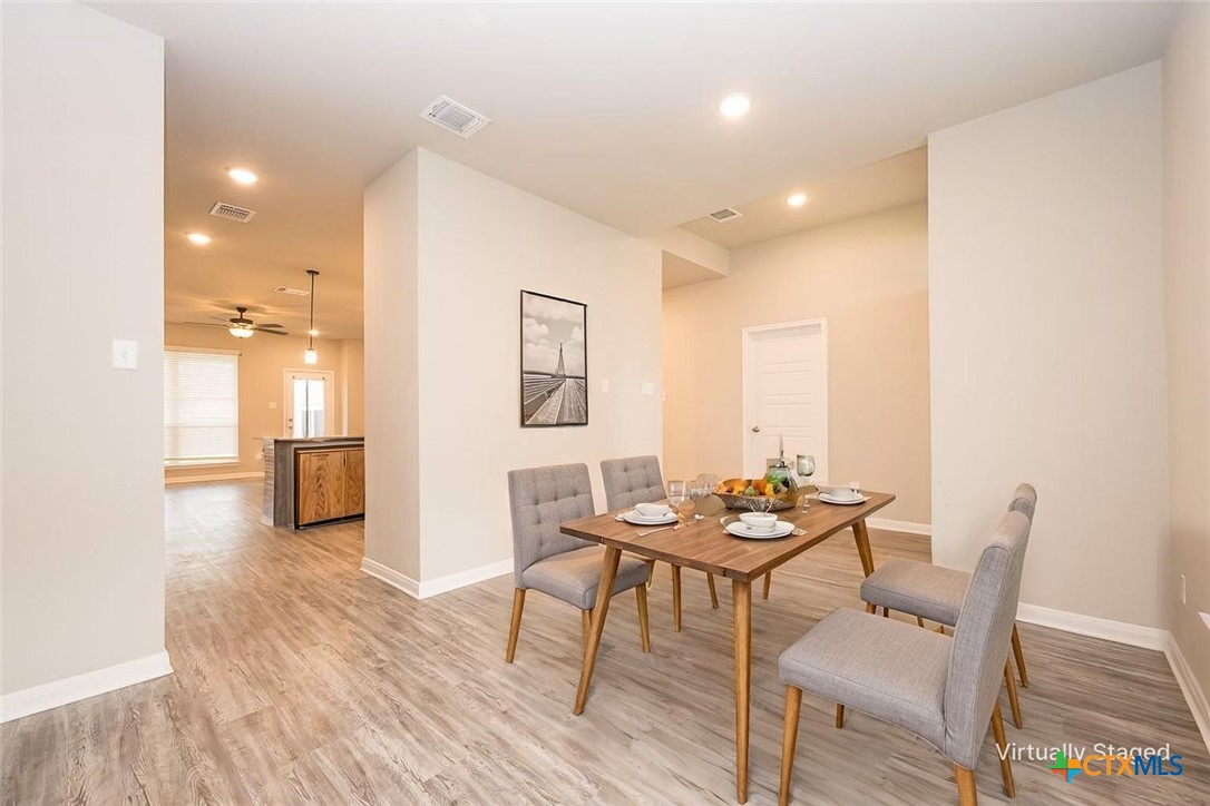 113 Lazy Lizzy Road Jarrell, TX 76537 - Photo 2 of 29 a view of a dining room with furniture and wooden floor