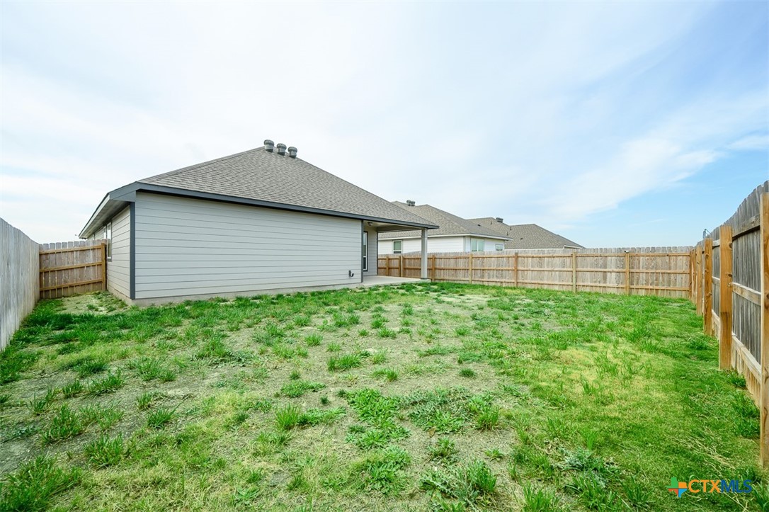 113 Lazy Lizzy Road Jarrell, TX 76537 - Photo 26 of 29 a backyard of a house with lots of green space