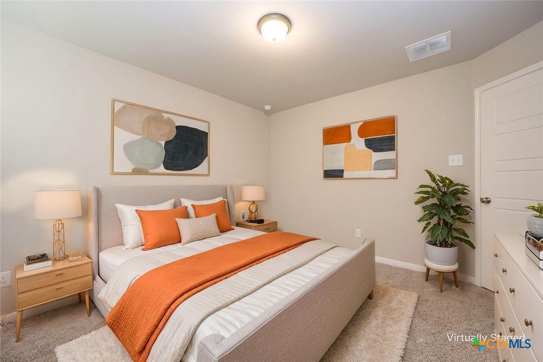 113 Lazy Lizzy Road Jarrell, TX 76537 - Photo 6 of 29 a bedroom with a bed and a potted plant