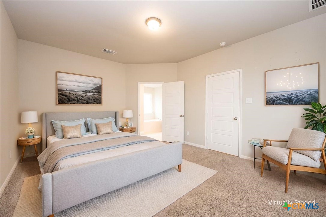 113 Lazy Lizzy Road Jarrell, TX 76537 - Photo 8 of 29 a bedroom with a bed and chair