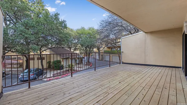 a view of a terrace with wooden floor and fence