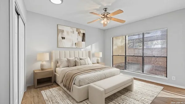 a bedroom with a large bed and a window