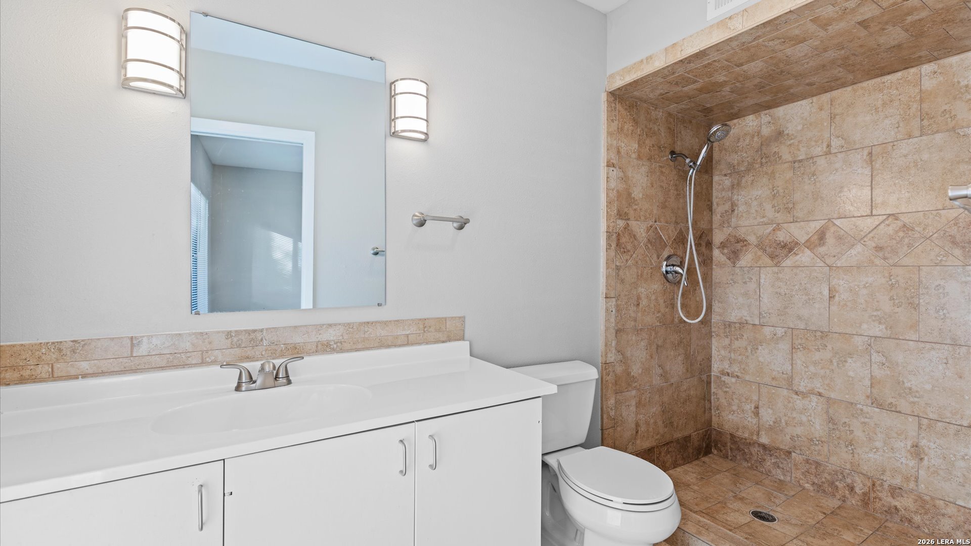 8642 Fredericksburg Road, Unit 405 San Antonio, TX 78240 - Photo 21 of 24 a bathroom with a sink a toilet and shower