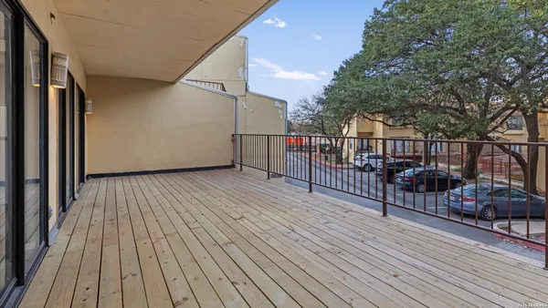 a view of a balcony with wooden floor